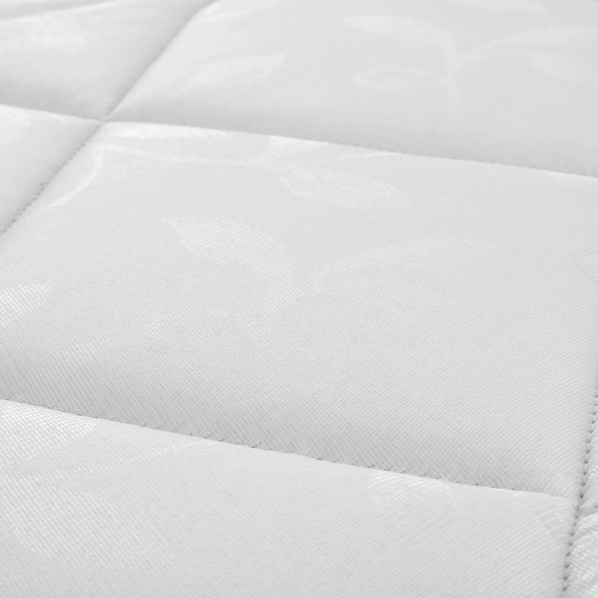 Closeup of Premier 90cm mattress fabric with quilted stitching and subtle leaf pattern