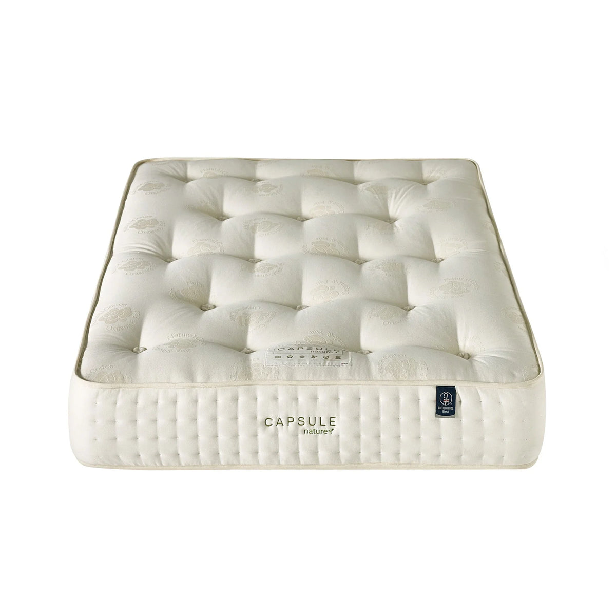 Double size mattress with tufted cream fabric cover and embroidered Capsule Nature label