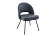 A modern dining chair upholstered in dark gray velvet with slim black metal legs, shown against a plain white background.