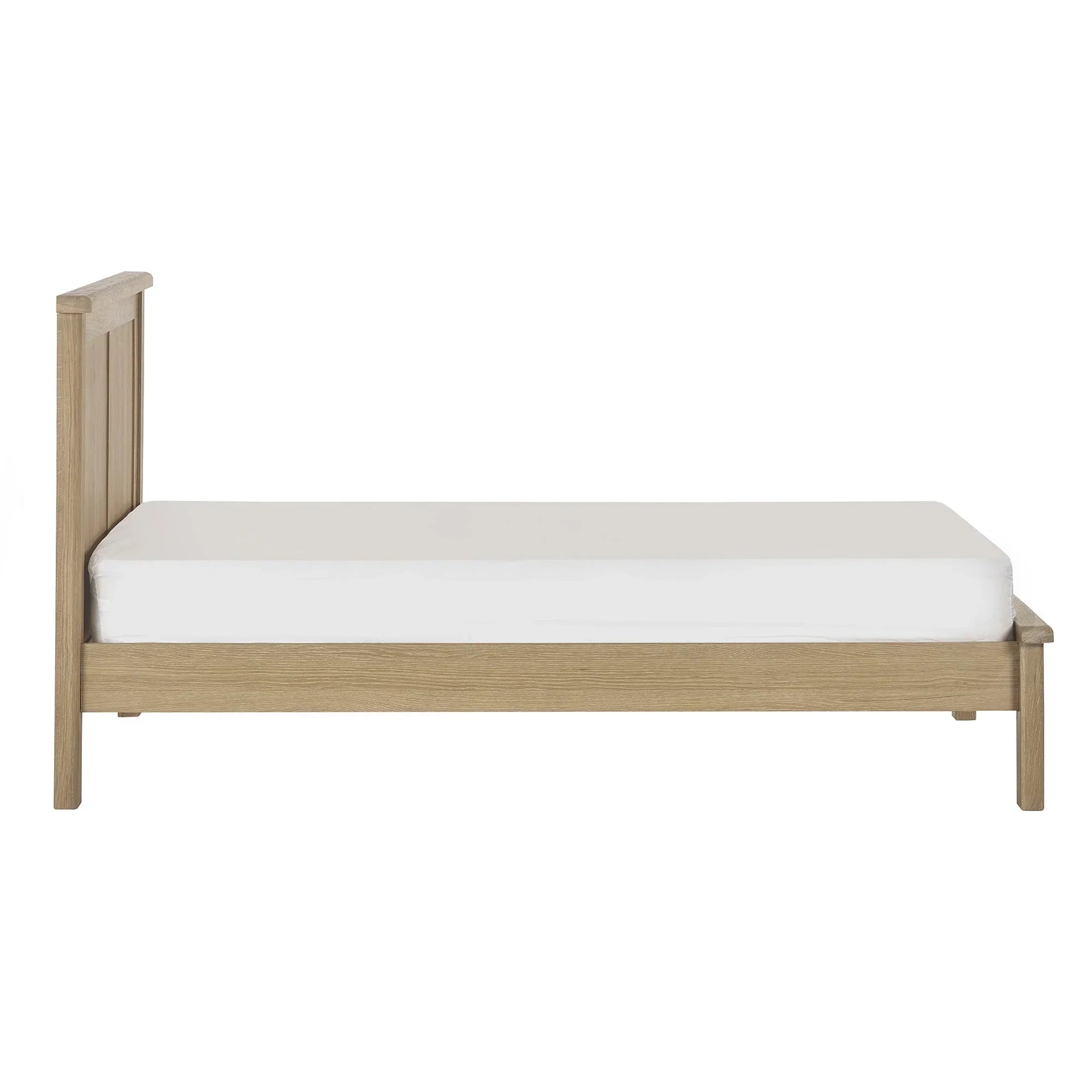 Limed oak bed frame with white mattress, side profile, panel headboard design