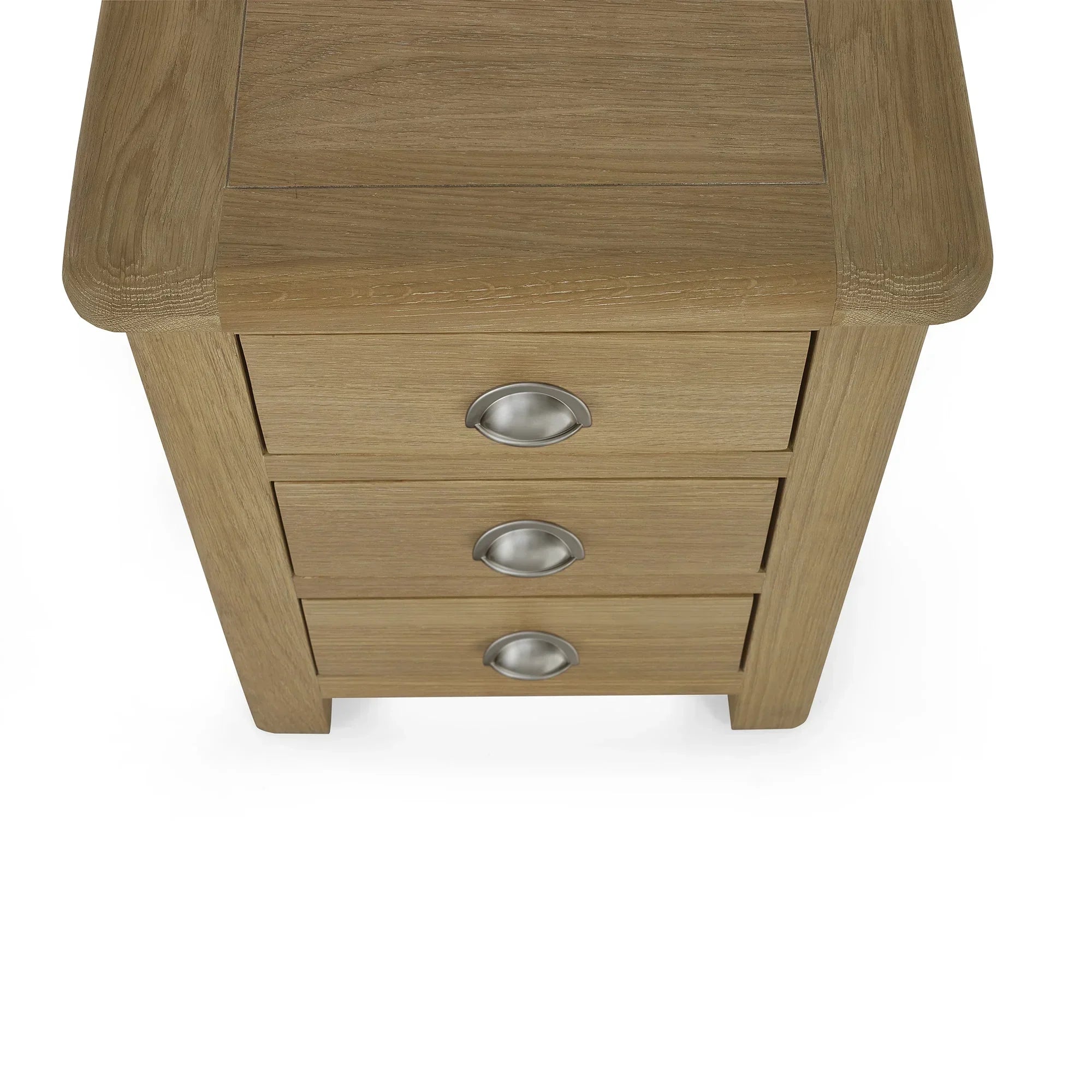 Limed oak 3 drawer bedside table with silver cup handles, top corner view
