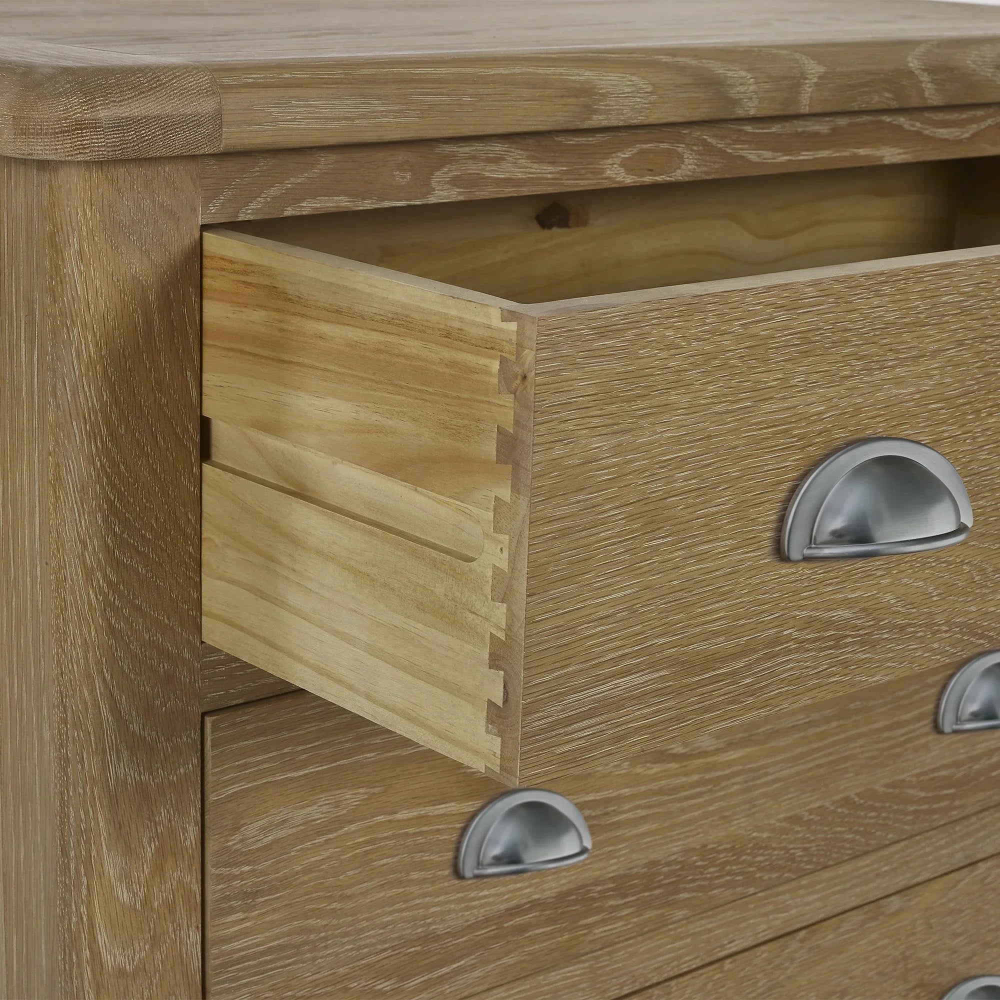 Memphis limed oak 3 drawer chest with metal cup handles, open dovetail drawer detail