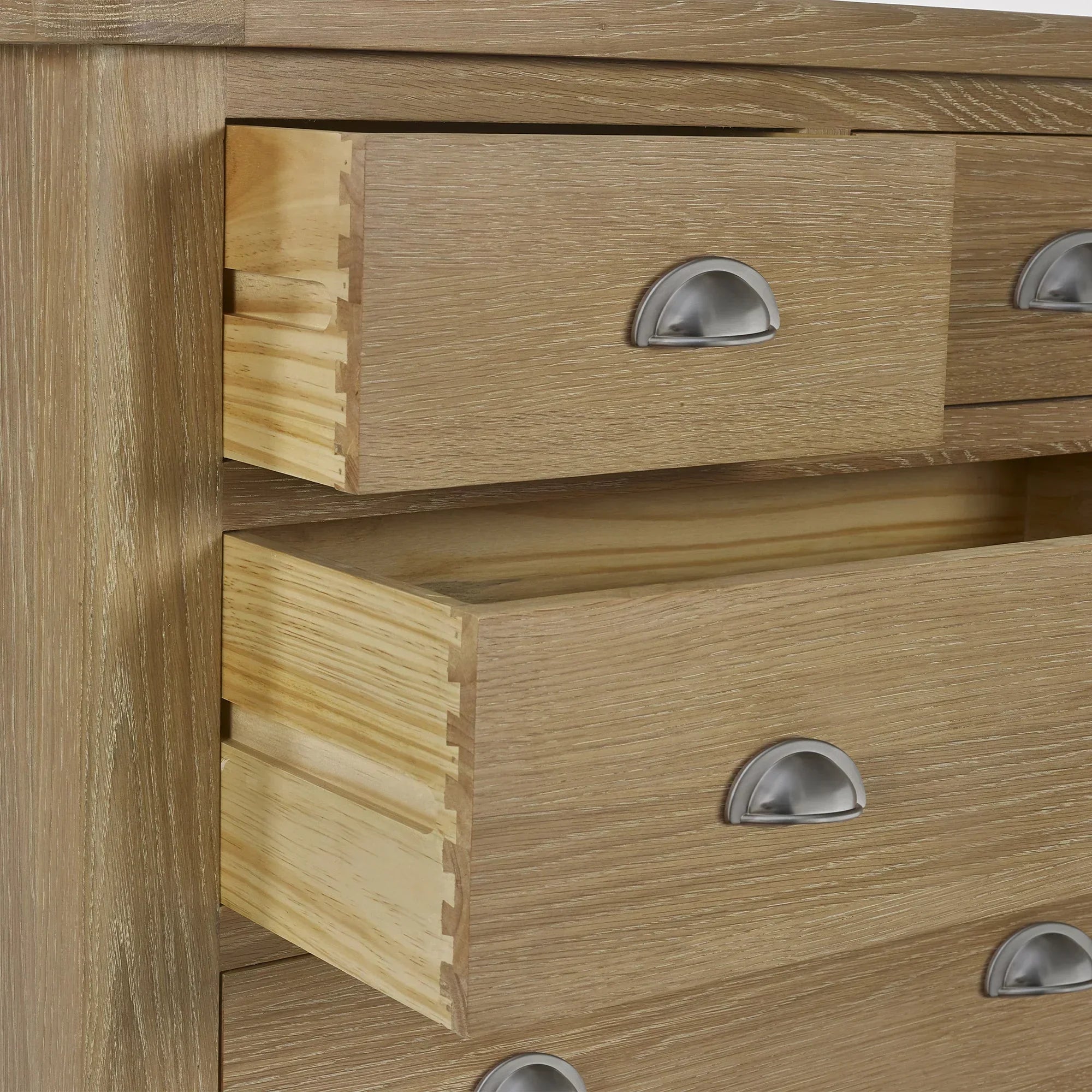 Close-up of limed oak 2 drawer chest with metal cup handles and visible dovetail joints