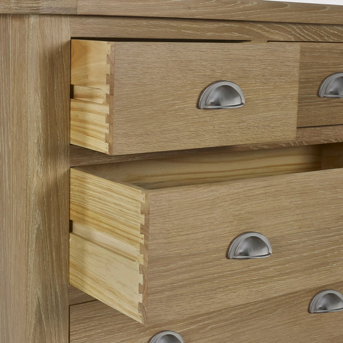 Close-up of limed oak 2 drawer chest with metal cup handles and visible dovetail joints