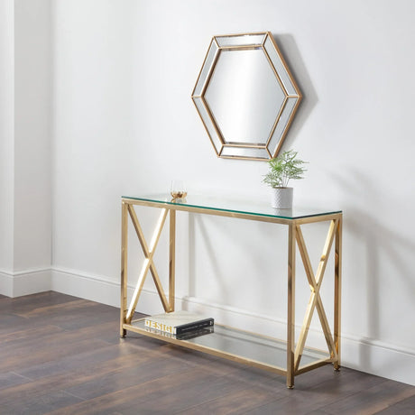 Glass console table with gold metal frame, shelf, and hexagonal wall mirror in hallway