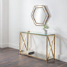 Glass console table with gold metal frame, shelf, and hexagonal wall mirror in hallway