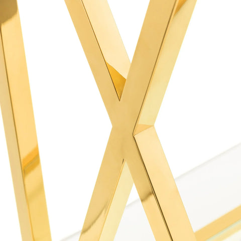 Gold metal table leg with X-shaped frame and glass tabletop corner detail