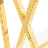 Gold metal table leg with X-shaped frame and glass tabletop corner detail