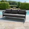 Charcoal grey outdoor sofa with rope armrests by a pool on a stone patio