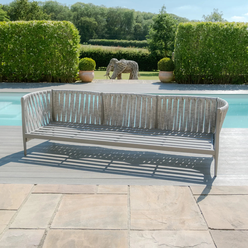 Modern outdoor rope garden sofa in grey finish beside swimming pool on patio