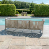 Curved outdoor sofa with woven rope design set by pool on stone patio