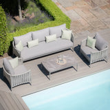 Grey outdoor sofa set with coffee table and cushions on poolside patio