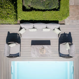 Grey outdoor sofa set with matching chairs and coffee table next to swimming pool on decking