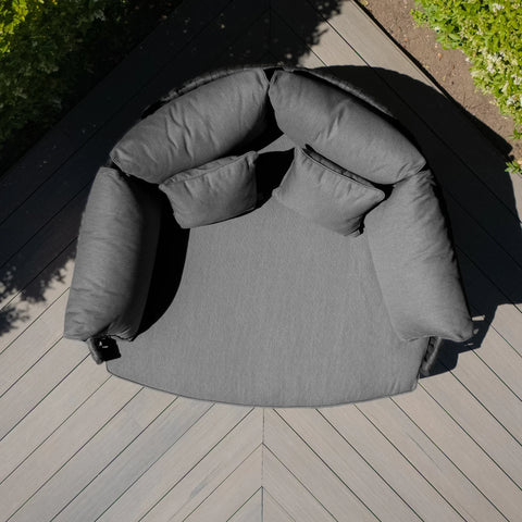 Charcoal grey outdoor daybed with plush cushions on composite deck