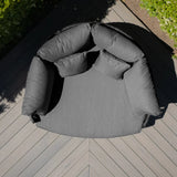 Charcoal grey outdoor daybed with plush cushions on composite deck