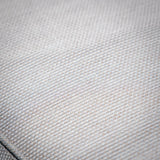 Beige sofa fabric upholstery closeup showing woven texture detail