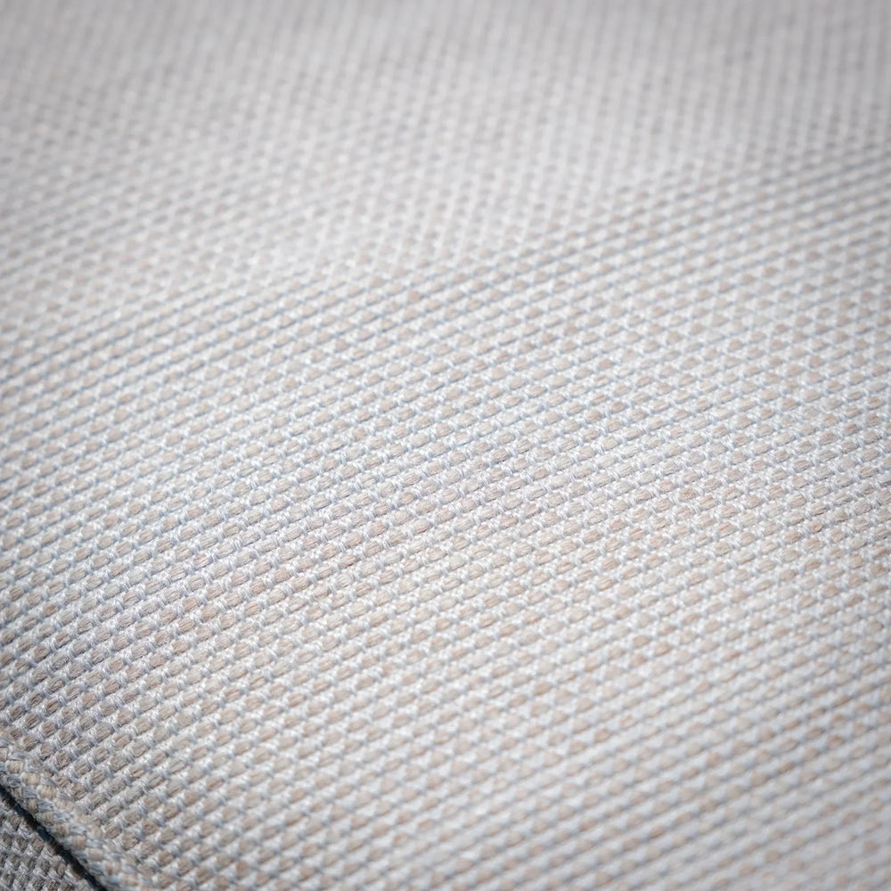 Closeup of light beige sofa fabric texture with subtle woven pattern