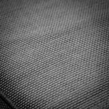 Close-up of grey fabric upholstery on sofa cushion showing textured weave