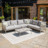 Grey outdoor corner sofa set with cushions and coffee table on patio rug