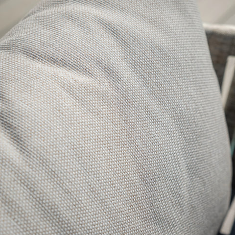 Close up of light grey woven fabric cushion on sofa