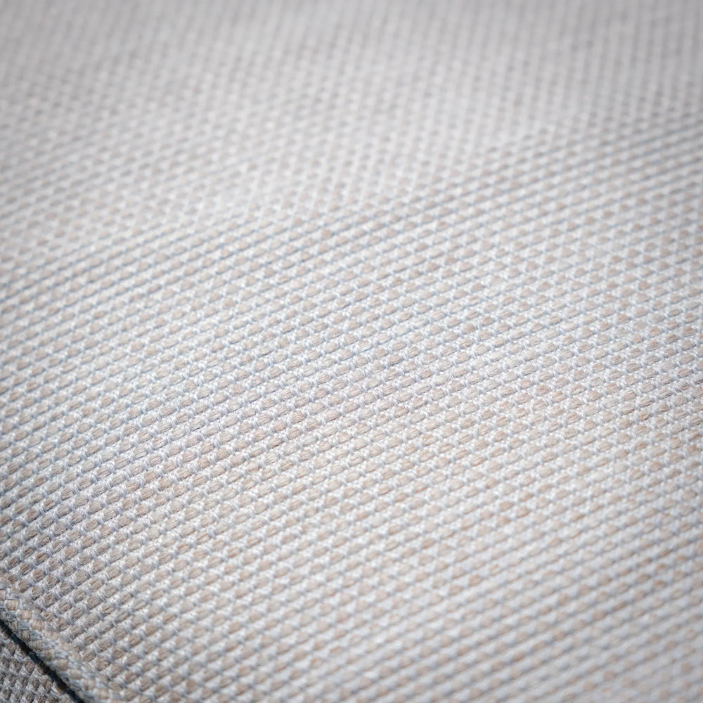Close-up of beige sofa fabric texture with detailed woven pattern