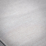 Close-up of beige sofa fabric texture with detailed woven pattern