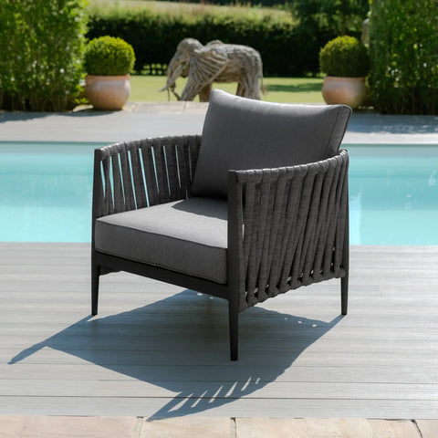 Grey outdoor lounge chair with rope detailing on patio beside pool