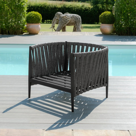 Contemporary black outdoor lounge chair with woven backrest on poolside decking