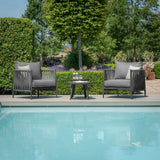 Outdoor rope armchairs and round table set beside pool on garden patio