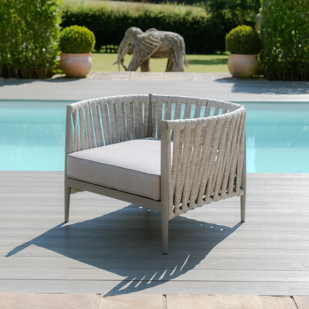 Rope outdoor armchair with grey cushion on decking beside swimming pool