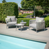 Outdoor garden furniture set with two grey lounge chairs and tables by poolside