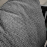 Close-up of grey fabric texture on sofa cushion