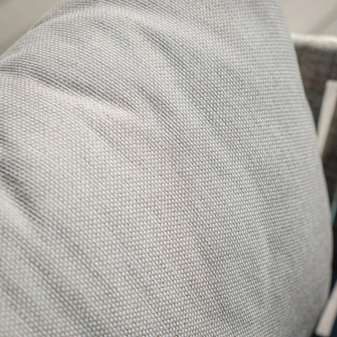 Close up of textured beige sofa cushion fabric with light grey woven pattern