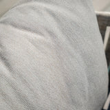 Close up of textured beige sofa cushion fabric with light grey woven pattern