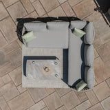 Grey outdoor corner sofa set with cushions and coffee table on patio tiles