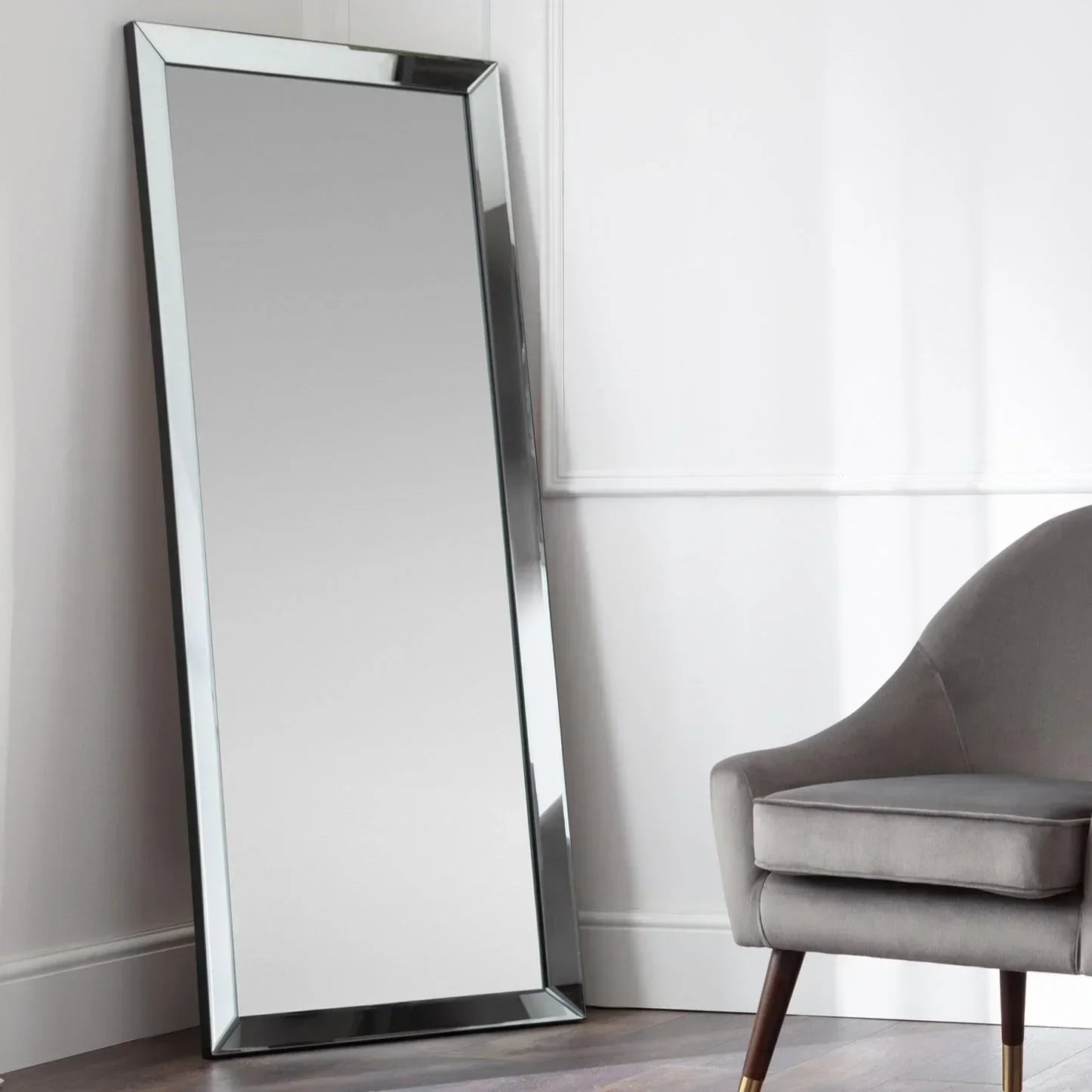 Soprano lean-to dress mirror with bevelled edge beside a grey accent chair in corner