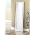 Palais white dress mirror with ornate frame leaning against beige wall in bright room