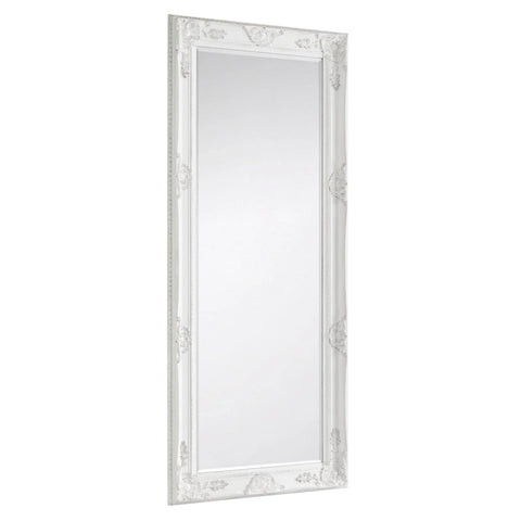 White ornate dress mirror with decorative carved frame, shown at an angled side view