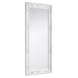 White ornate dress mirror with decorative carved frame, shown at an angled side view