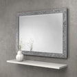Rectangular wall mirror with decorative silver textured frame above a white floating shelf