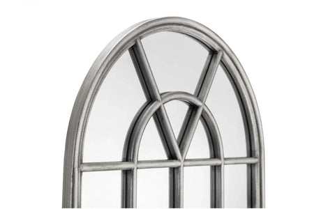 Arched wall mirror with distressed silver metal frame and decorative windowpane design