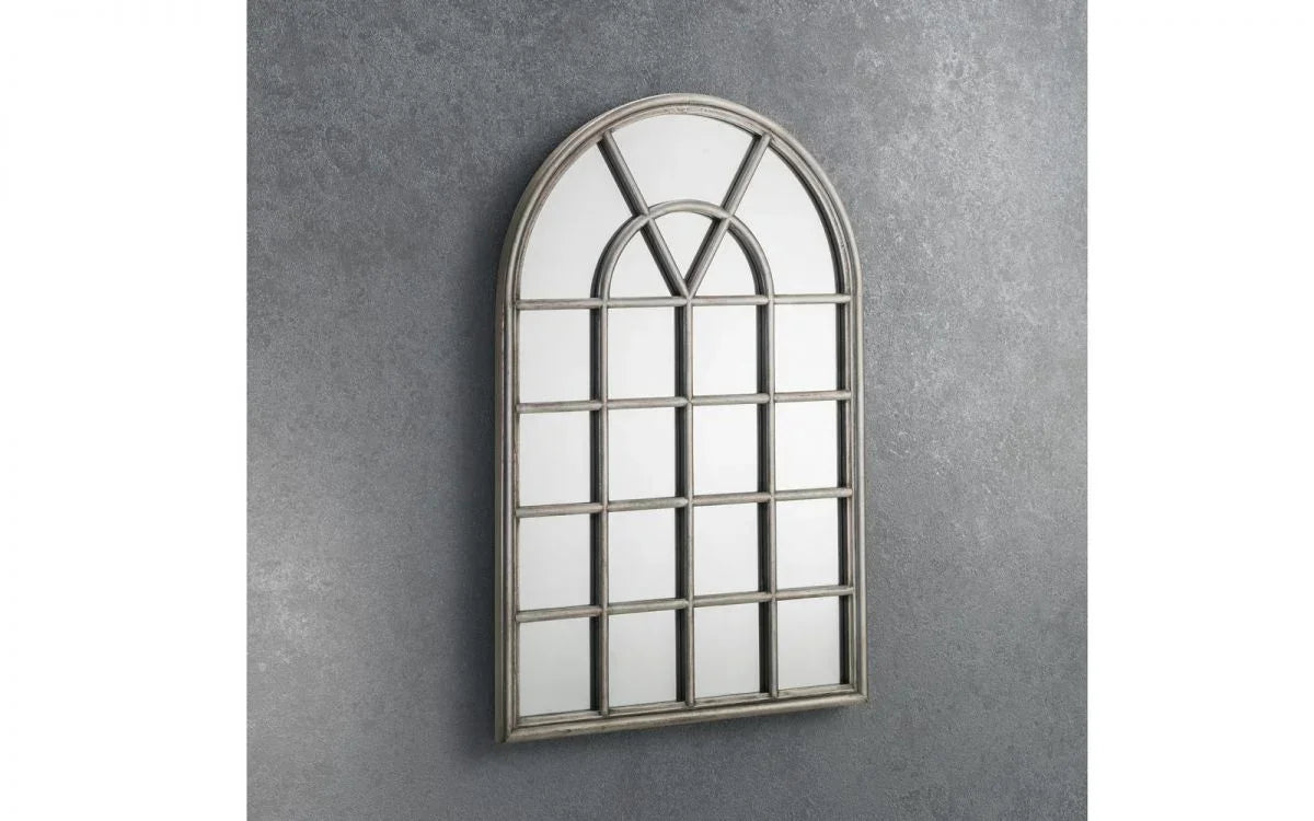 arched window mirror with grid design and grey frame on textured wall