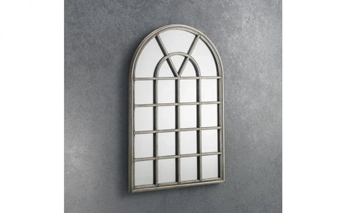 arched window mirror with grid design and grey frame on textured wall