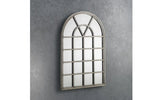 arched window mirror with grid design and grey frame on textured wall