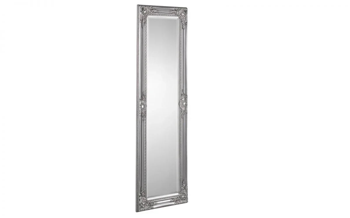 Tall silver ornate wall mirror with decorative carved frame, angled view