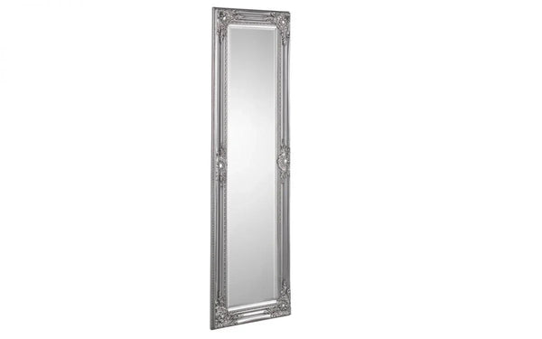 Tall silver ornate wall mirror with decorative carved frame, angled view