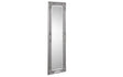 Tall silver ornate wall mirror with decorative carved frame, angled view