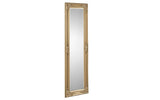 Tall gold ornate framed mirror with decorative detailing shown at an angle