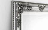 Silver ornate wall mirror with detailed floral frame corner close-up