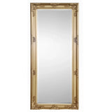 Gold dress mirror with ornate frame and full-length reflective surface